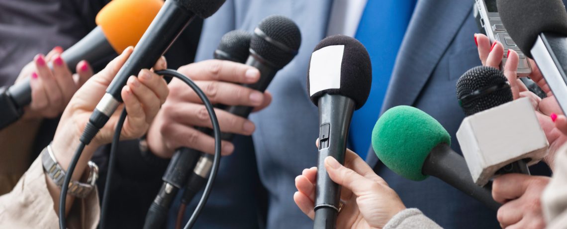 Media interview - group of journalists surrounding VIP