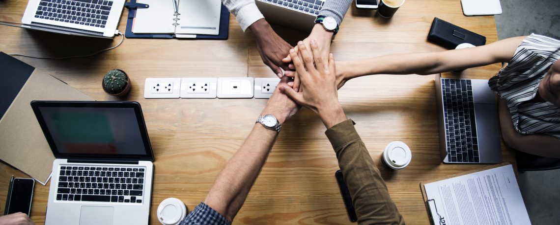 Team of business people stacking hands