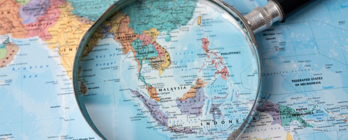 Bangkok, Thailand - August 01, 2020 Asia, Magnifying glass close up with colorful world map