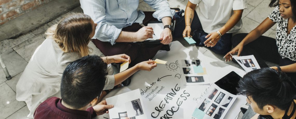 Business people brainstorming management process on paper