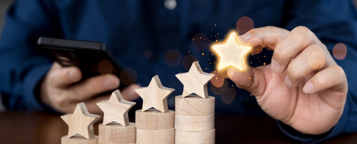 Close up of businessman customer giving a five star rating on smartphone. Review, Service rating, satisfaction, Customer service experience and satisfaction survey concept