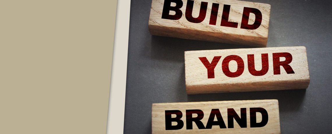 Build yor brand words on wooden blocks on black background. Marketing branding business concept