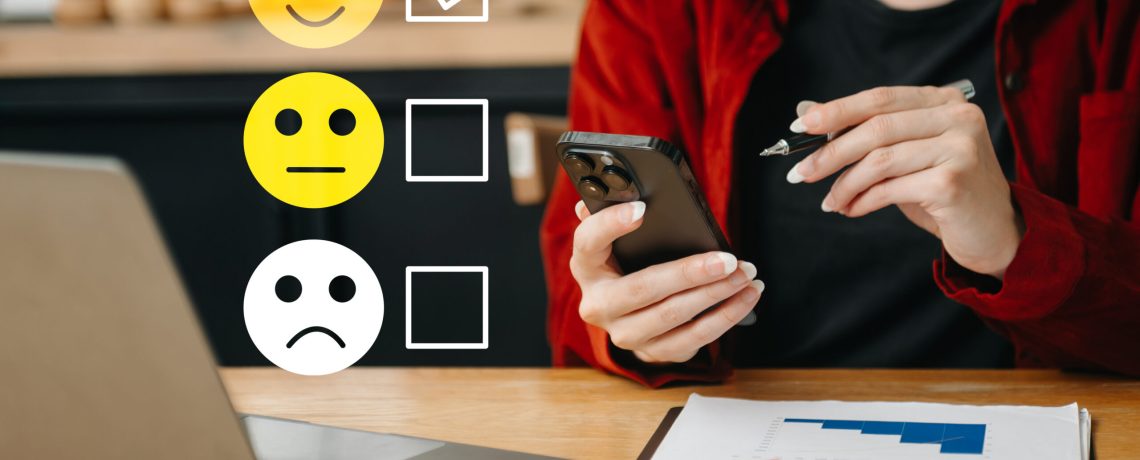 Customer service evaluation concept. woman Show face smile emoticon show on virtual screen from hand.looking at smart phone, tablet and laptop